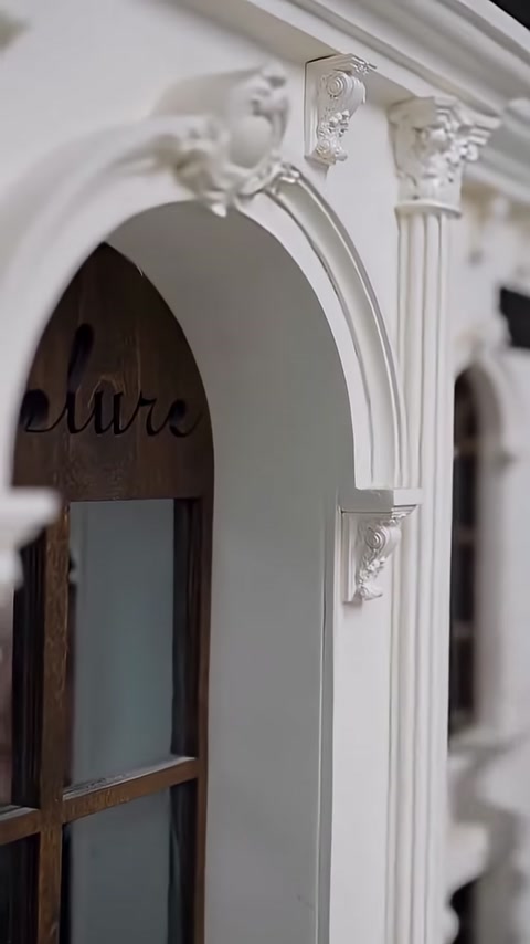 Symmetrical corbel applications around an arched window are shown in close-up