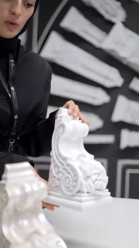 The curved side profile of a decorative corbel is shown on a table