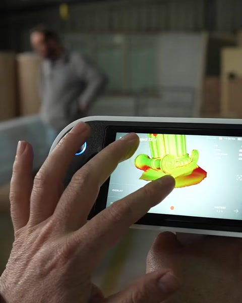 Hand touching tablet screen showing a 3D scanned column model