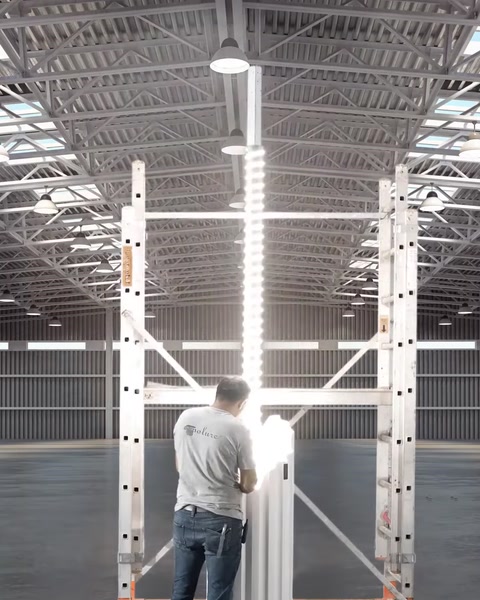 Worker installing a polyurethane column piece on factory scaffold