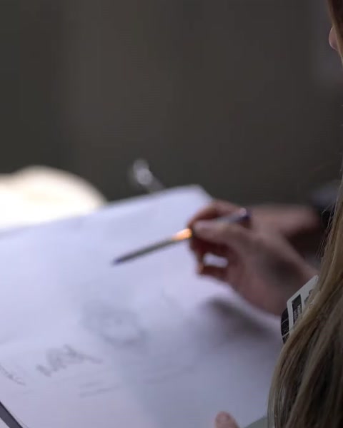 Designer hand-sketching a column profile design on paper