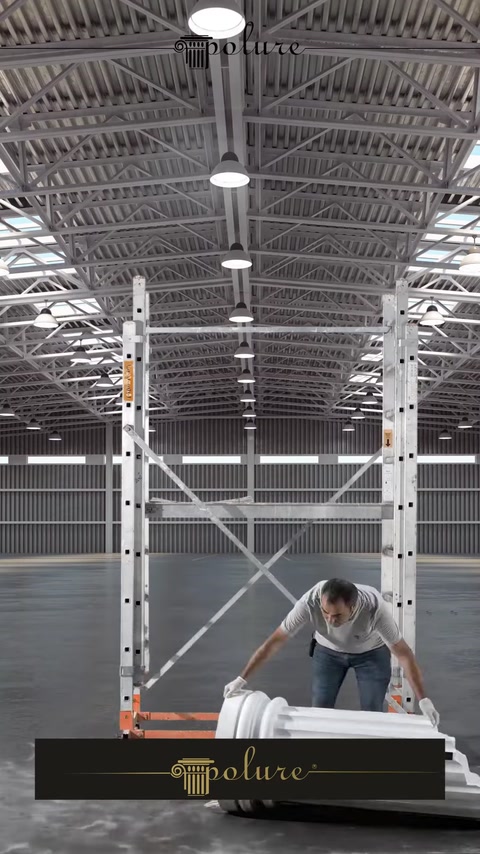 Production hall with tall scaffolding used for column assembly