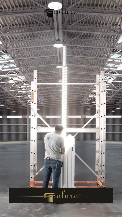 Worker installing a polyurethane column piece on factory scaffold
