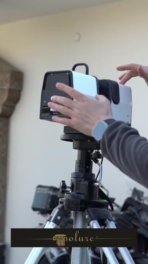 Technician scanning an architectural facade with handheld 3D scanner