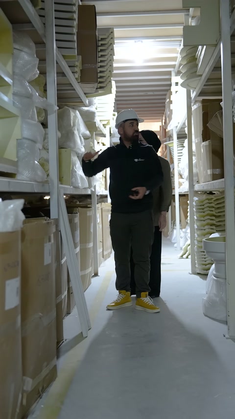 Cream-colored curved profile displayed by hand in front of the shelves