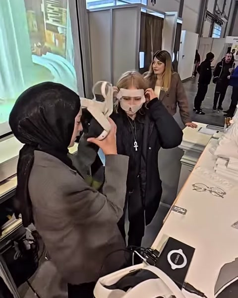 Una donna con visore per la realtà virtuale viene guidata in un interno neoclassico virtuale