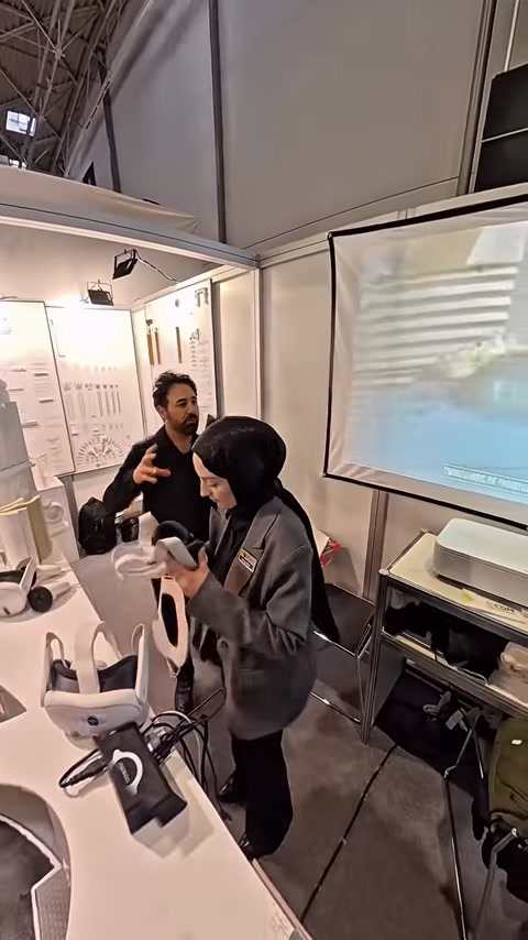 Man and woman testing VR headset near architectural product display