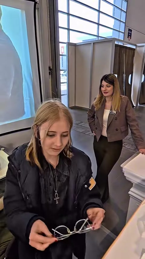 Two women standing beside booth counter with decorative polyurethane pieces
