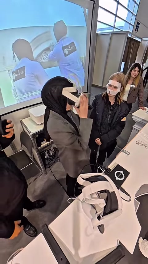 Woman using VR headset with virtual columns visible on nearby screen