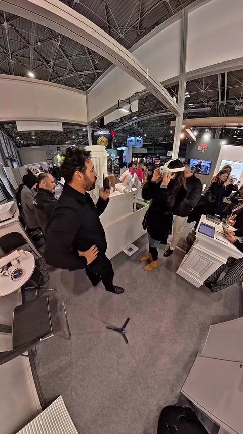 Visitors viewing monitor screens showing architectural visualization content