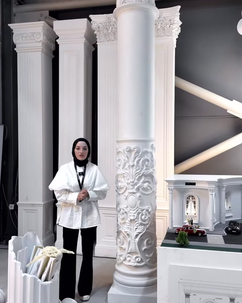 A full-height decorative column features a smooth shaft and an embossed section.