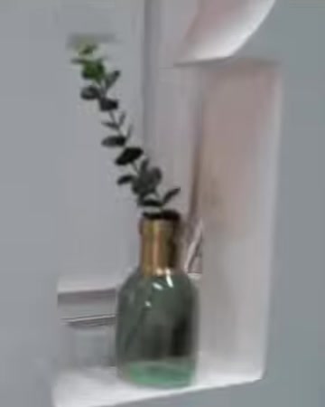 A curved decorative niche is presented with a vase and plant
