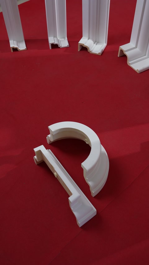 Curved column sections and linear profiles arranged on a red surface