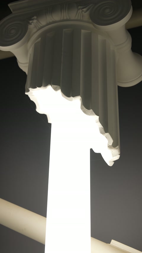 Illuminated fluted column detail creates a bright sculptural vertical feature