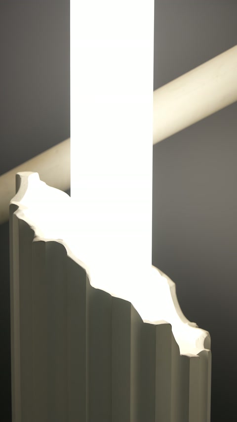 Glowing decorative band wraps around the dark fluted column shaft
