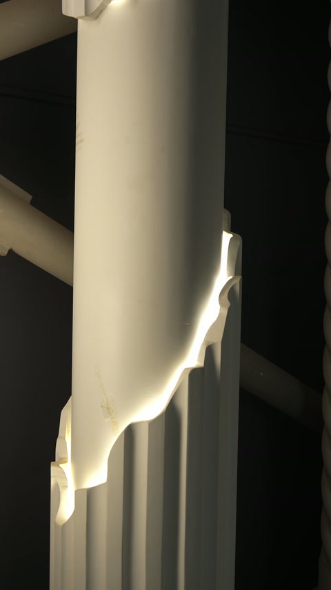 Smooth column shaft features an illuminated ornamental transition detail