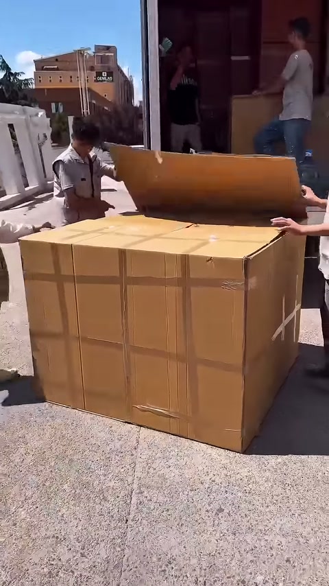 I lavoratori separano i coperchi opposti dell'imballaggio verso l'esterno