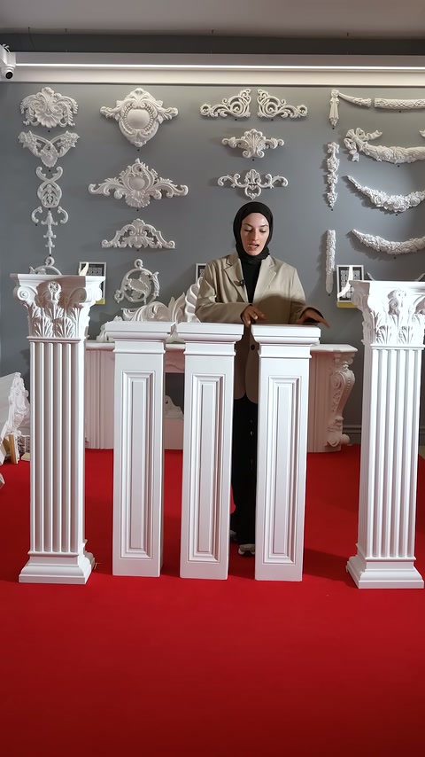 Four short decorative columns are arranged side by side for display in the showroom.