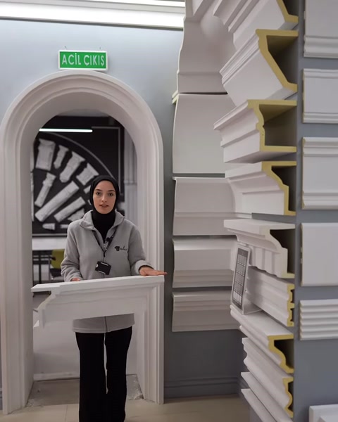 Presenter closely introducing a wide-profile polyurethane window trim example