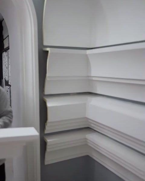 Decorative moulding designs in different widths arranged along a wall