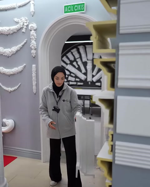 Presenter examining a variety of polyurethane profiles on a showroom shelf