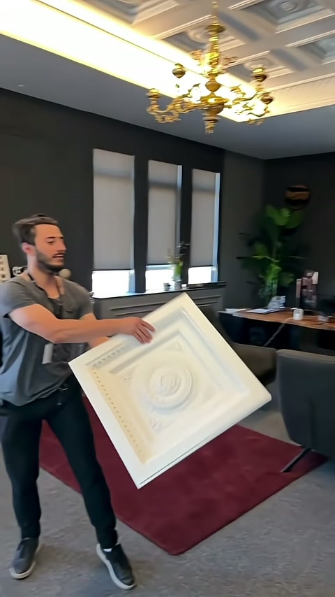 Interior frame and center rosette of square panel held in hand are highlighted.