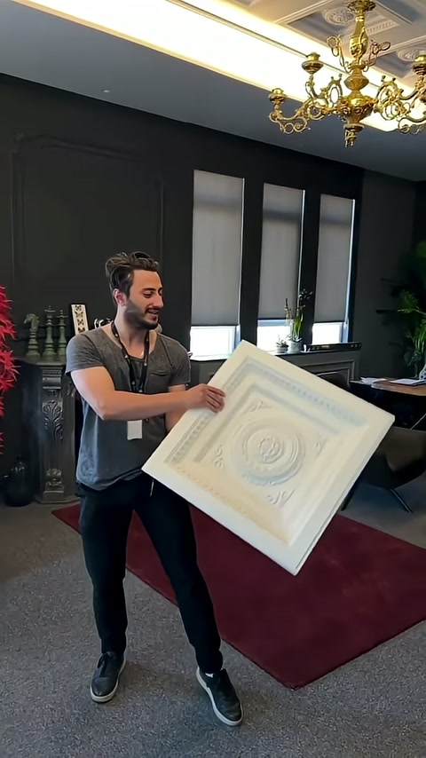 Square panel shown at an angle in a room with dark walls.
