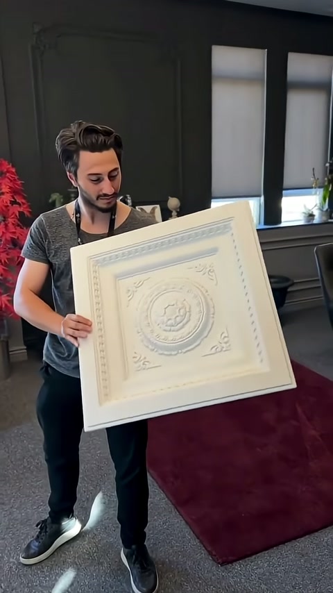 Presenter holds panel in front of body to display complete design.
