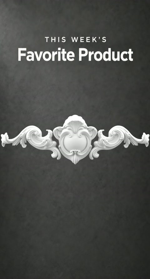An ornate scrollwork crest is displayed as a fireplace decorative component.