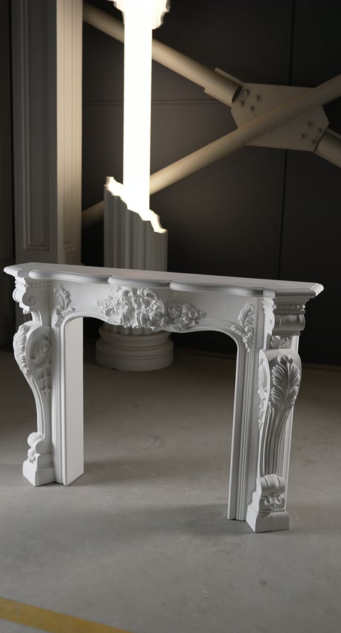 Ornate mantel assembly rests on the floor during workshop presentation.