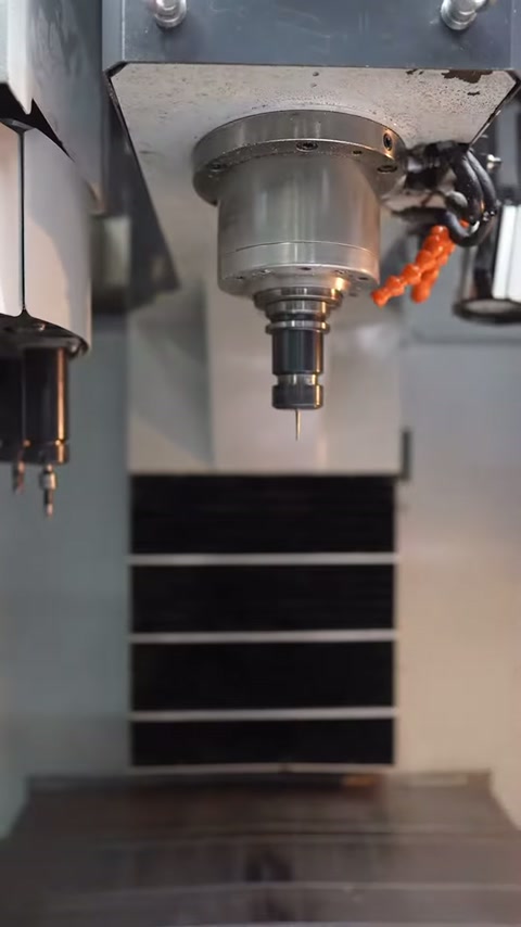 Cutting tool on the CNC machine approaches the white panel piece
