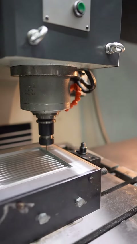 Milling head advances creating parallel grooves on the panel surface