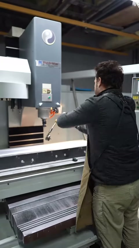 Worker manually repositions the control apparatus on the processing table