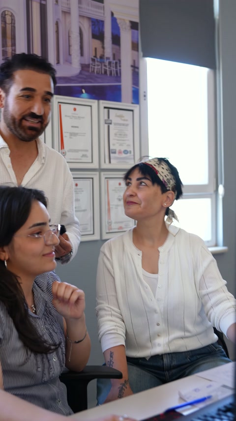 Two designers and an expert discuss project details together in the office.