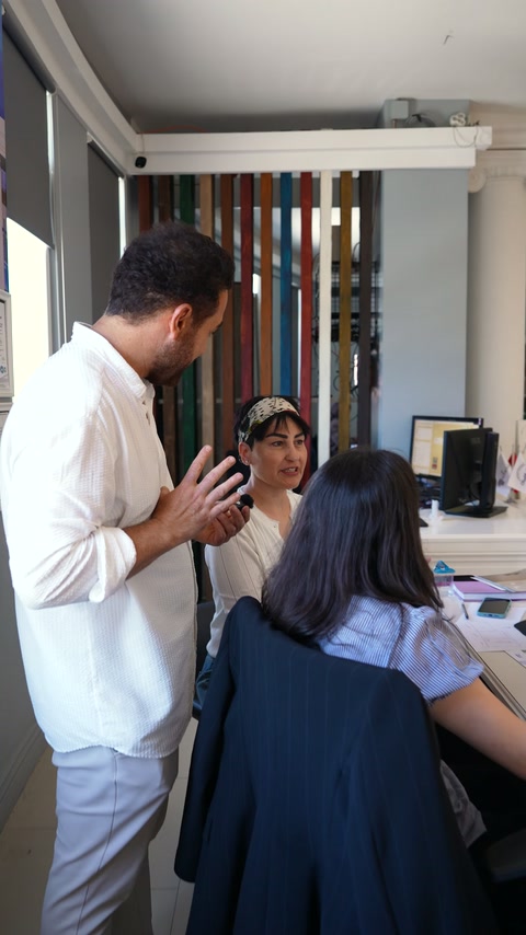 An expert and designer discuss decorative products in a showroom meeting.
