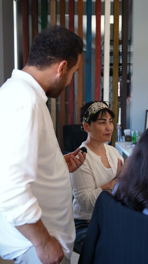 A designer and expert evaluate product details in an office meeting.