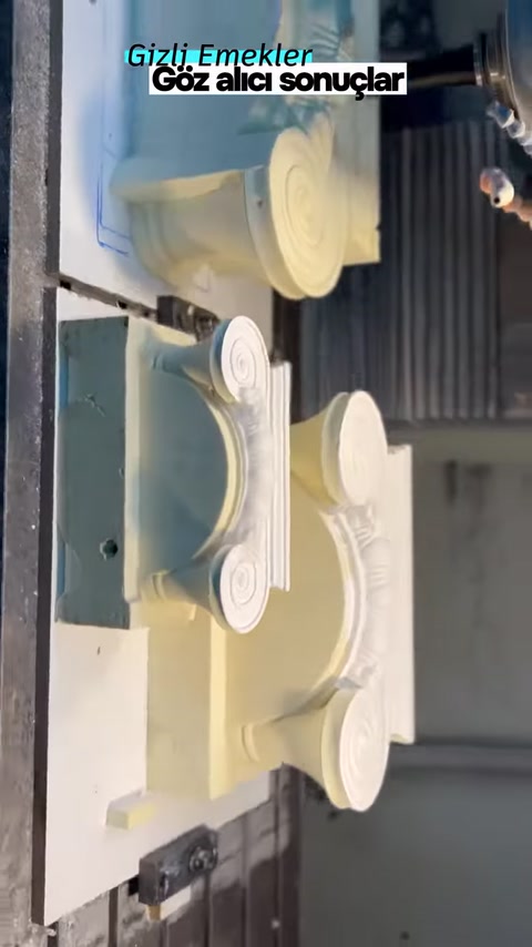 The curved body of the Ionic column capital is being processed by machine