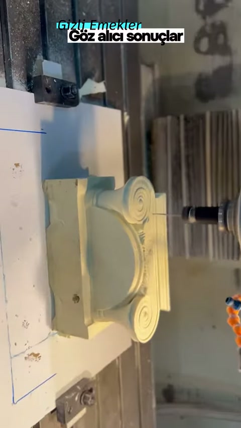 Light-colored column capital on the CNC machine viewed from the side