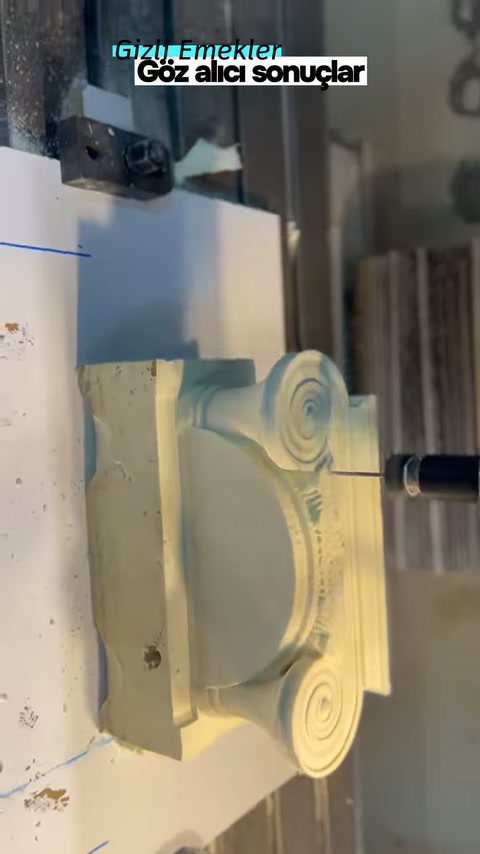 Rotating cutter approaches the right edge of the column capital's surface