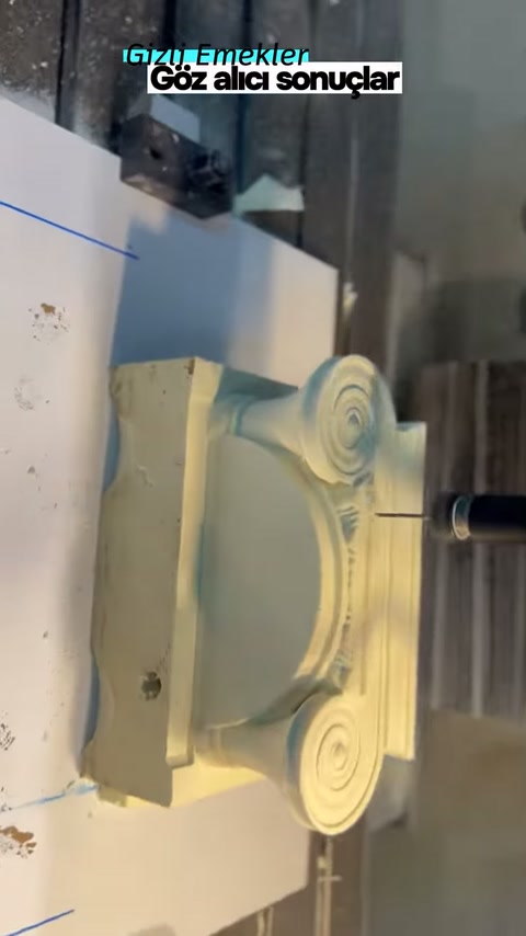 Symmetric volutes and flutes are traced on the decorative element on the bench