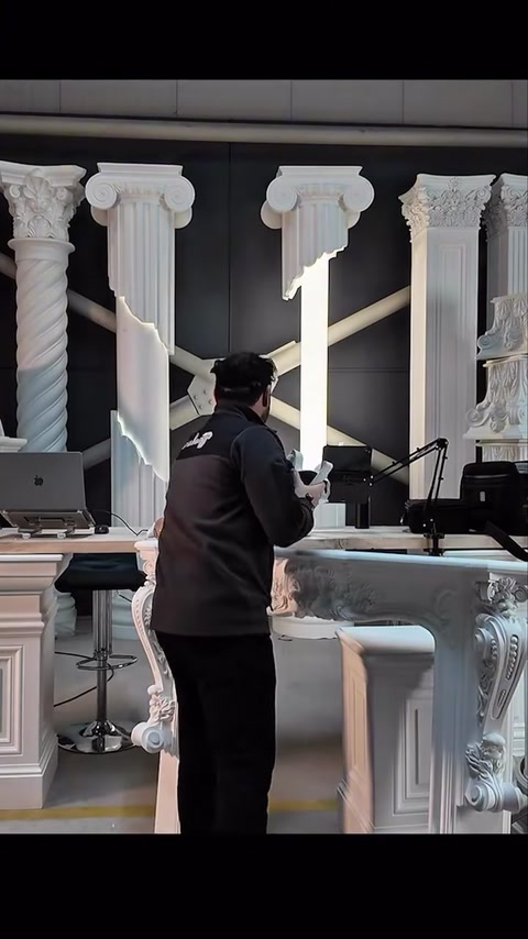 The specialist adjusts the VR headset by hand among column models.