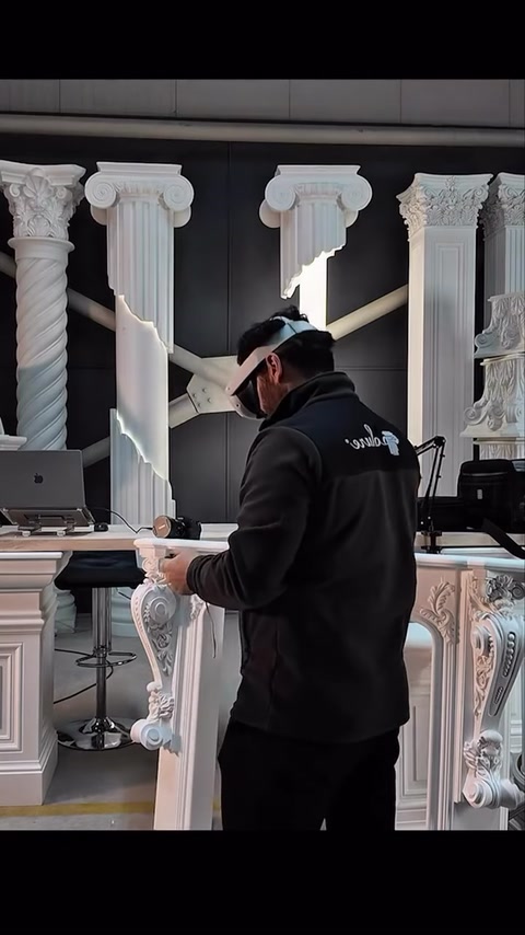 VR controllers are used in front of the real fireplace and columns.