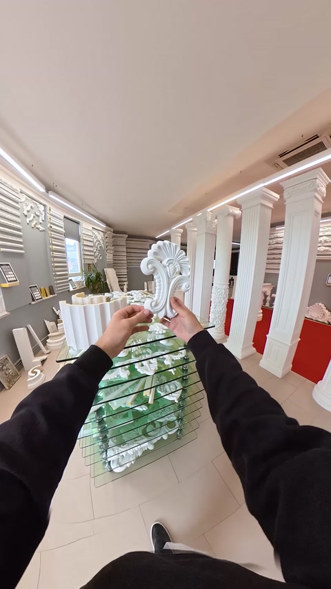 Product detail of a white decorative piece in a scrolling leaf shape