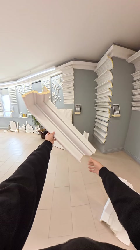 Two white cornice profile samples with different cross-sections