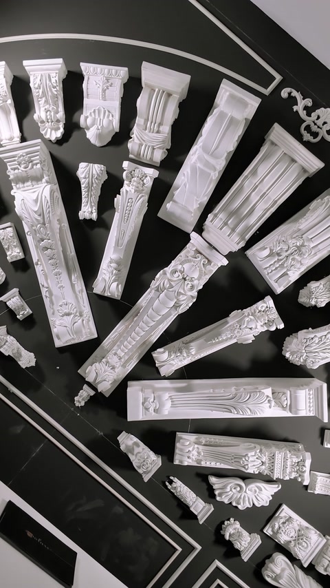 Assorted decorative moldings and architectural elements arranged for inspection.