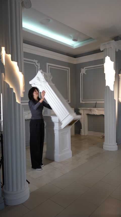 Finished interior features a decorative arch, columns, and ceiling moldings.