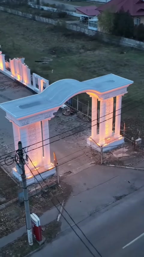 Elevated overview of the arched entrance gate and columns