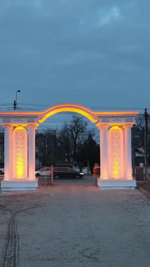 Main entrance designed with an illuminated arch and symmetrical columns