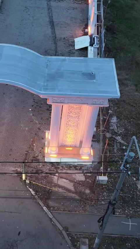 Upper covering of the entrance arch and illuminated decorative columns