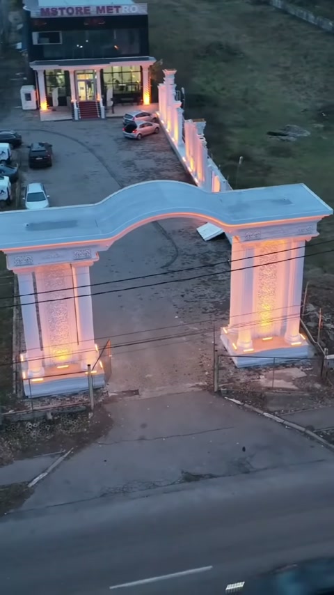 Decorative door application completed with wide opening and illuminated base pillars
